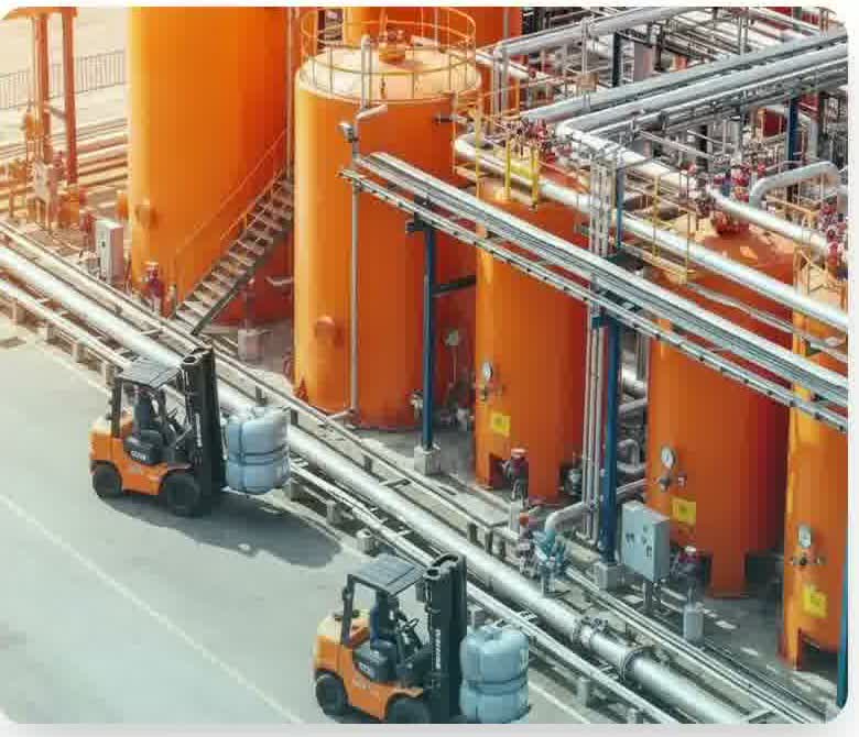 Bulk LPG storage tanks with forklifts moving cylinders